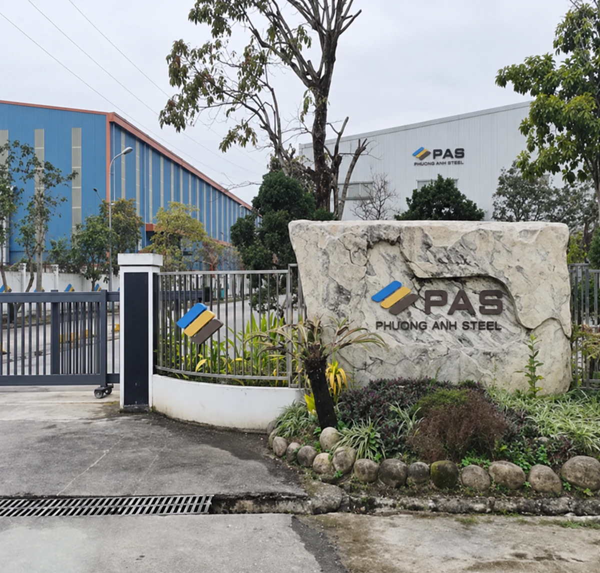Northern Vietnam factory premises entrance with PAS signage, enhanced with AI